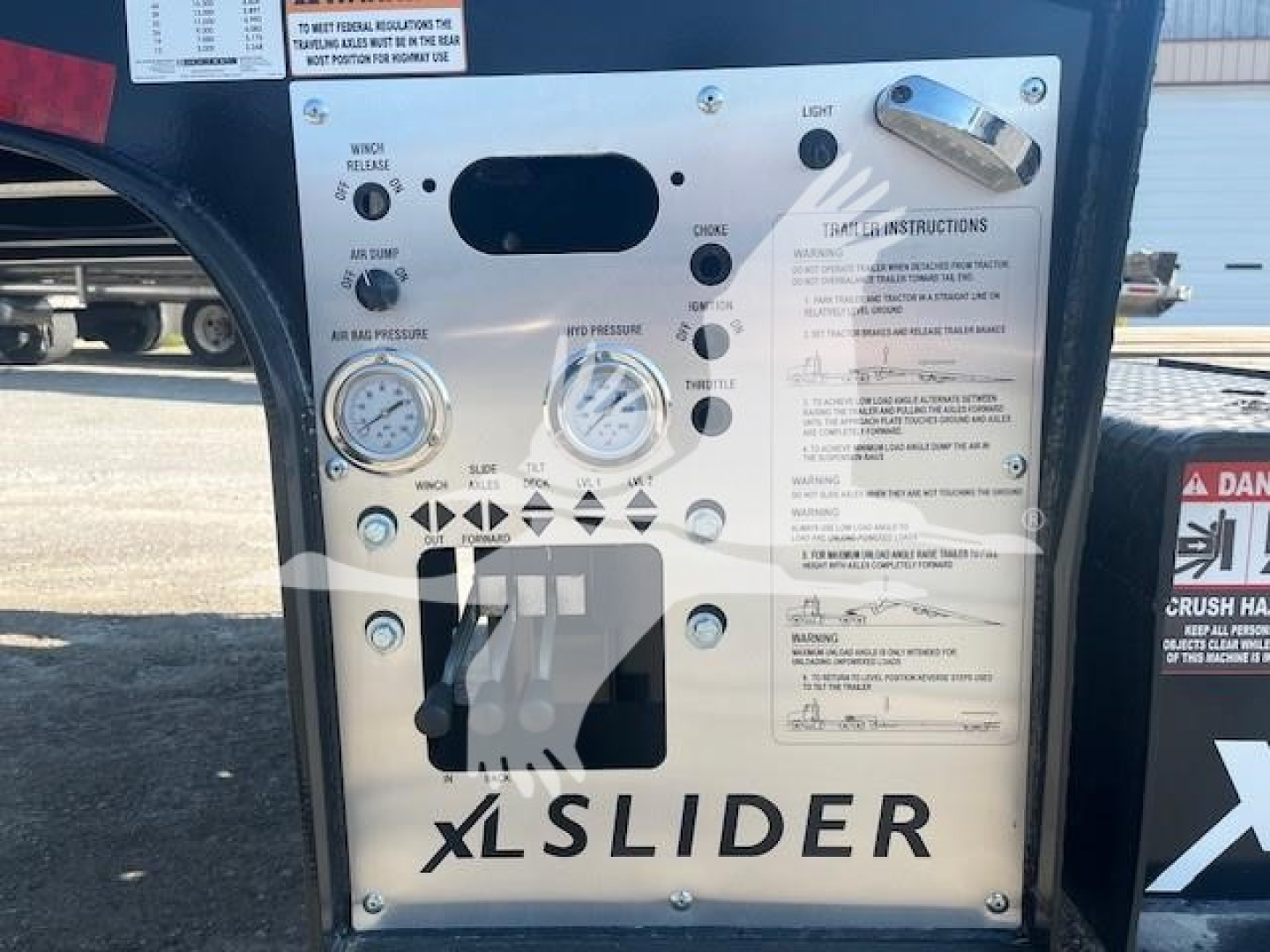 XL Specialized trailer control panel with gauges and switches showing warning labels and the word XLSLIDER