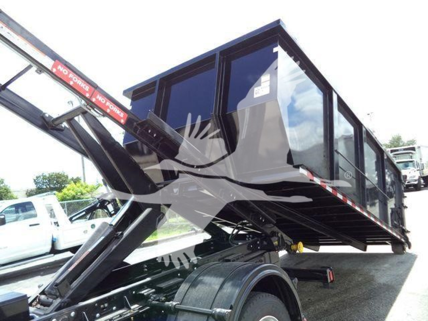 Truck bed with a mounted dump/drawer system on a Chevrolet Silverado 6500HD chassis, glass cab and black metal frame visible.