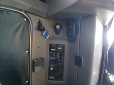 Cab interior panel of Kenworth W900L showing ignition switch, control switches, and gauge cluster; VIN and stock info not visible in image.