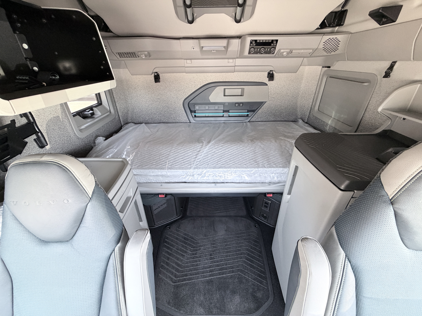 Volvo VNL sleeper cab interior with bunk bed and storage compartments