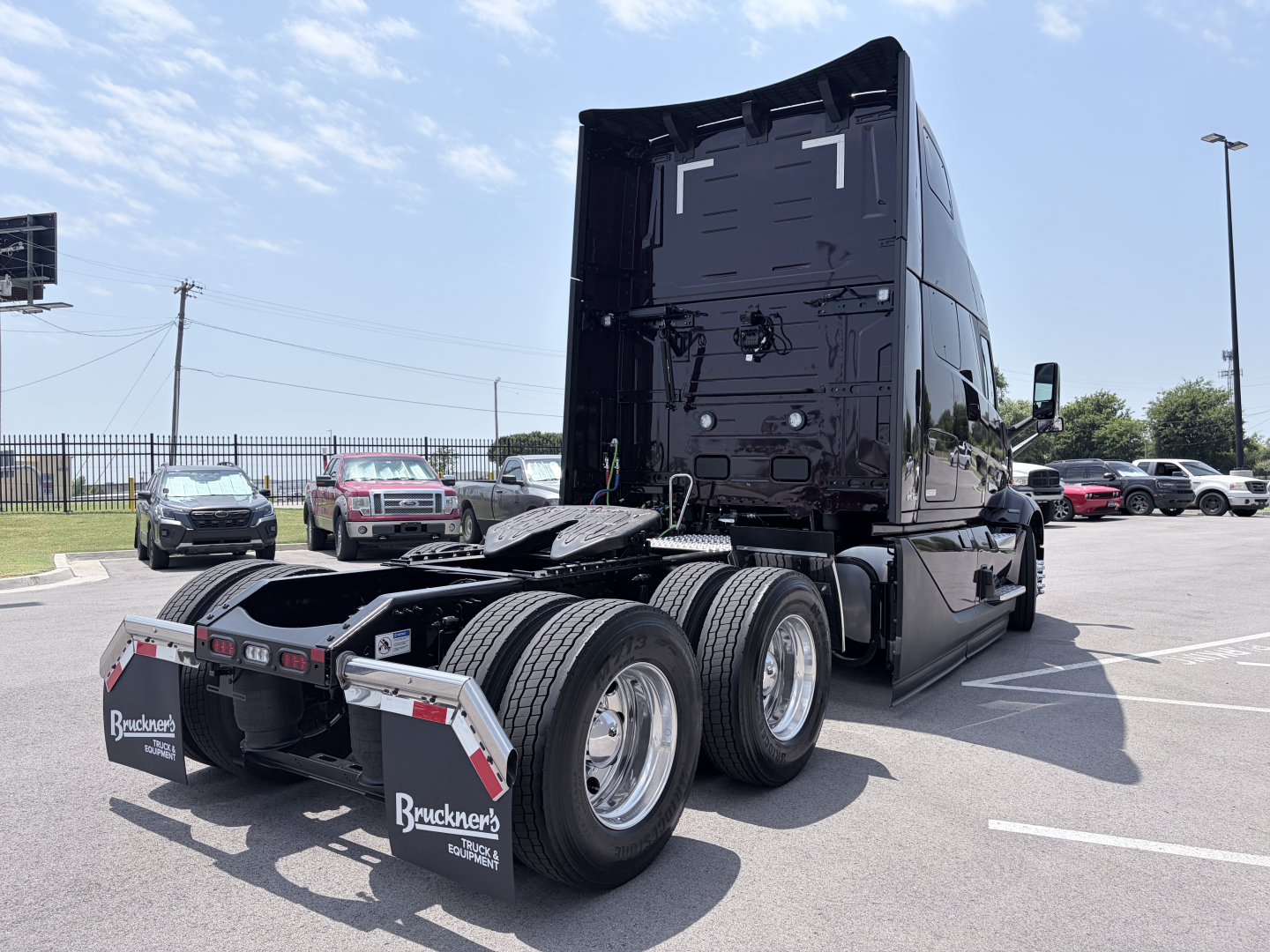 Volvo VNL64T860 tractor rear view showing dual rear axles and fifth-wheel profile.