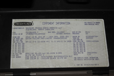 Freightliner component information label on engine bay showing VIN, stock number, and 125 Cascadia details.