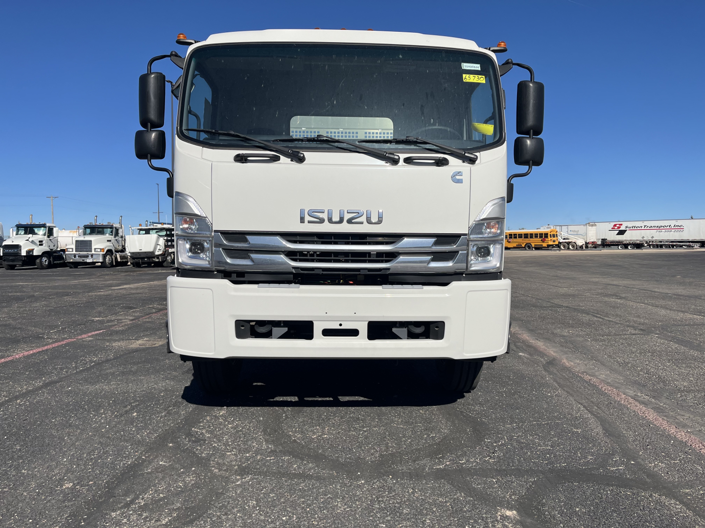 Isuzu FTR front view showing large grille, bumper, windshield, and side mirrors.