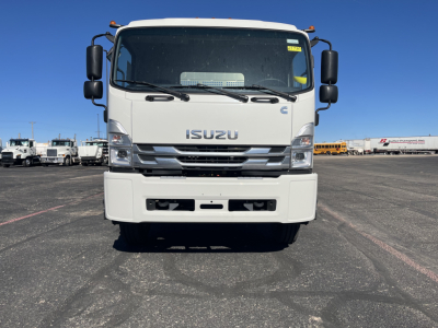 Isuzu FTR front view showing large grille, bumper, windshield, and side mirrors.