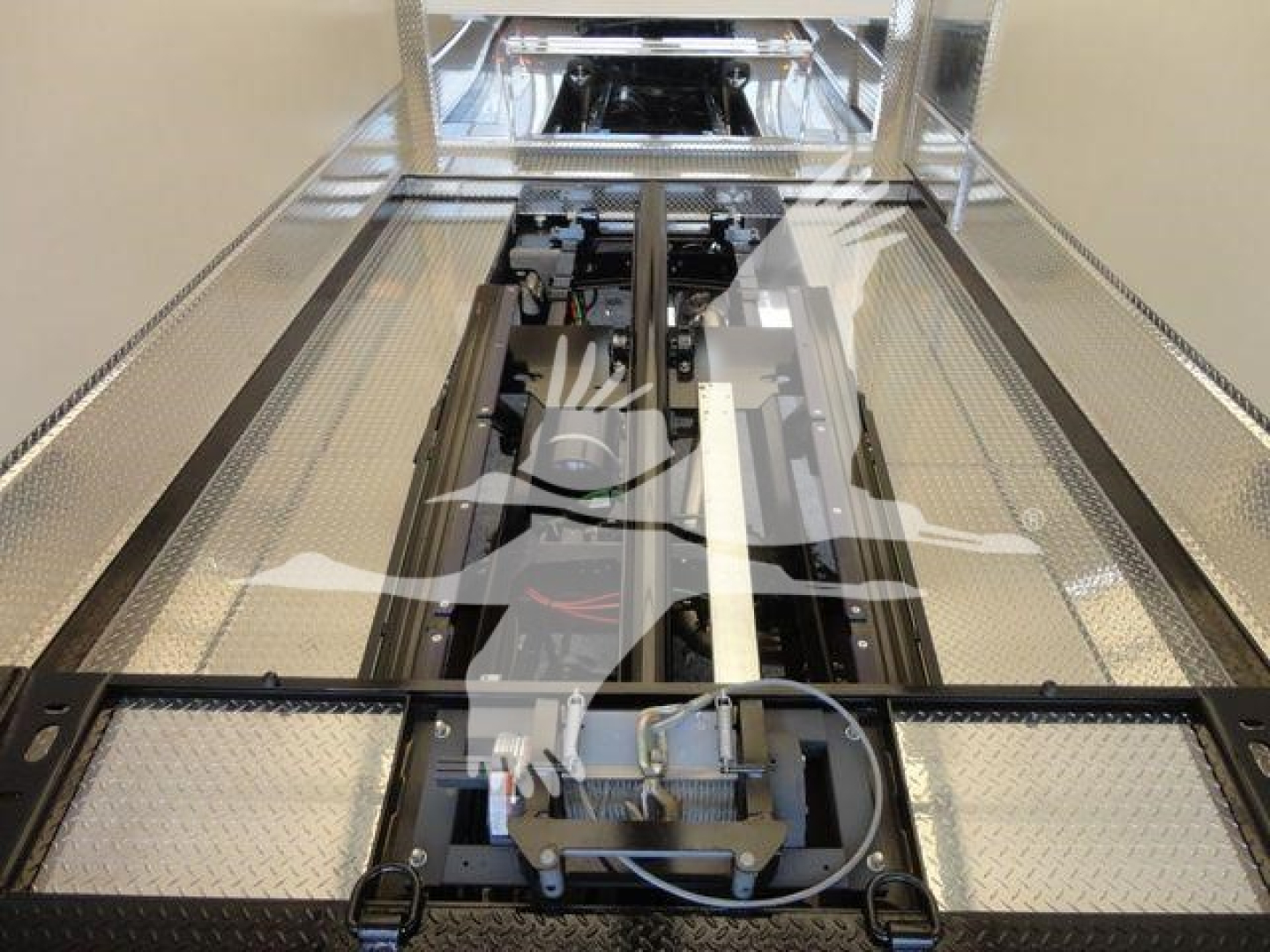MD6 truck chassis/frame inside service or transport area showing mounting platform, hydraulic lines, and chassis rails.