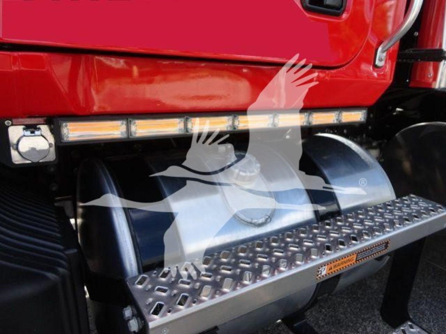 MD6 rollback truck showing side step and fuel tank area with metal diamond-plate step and safety tread.