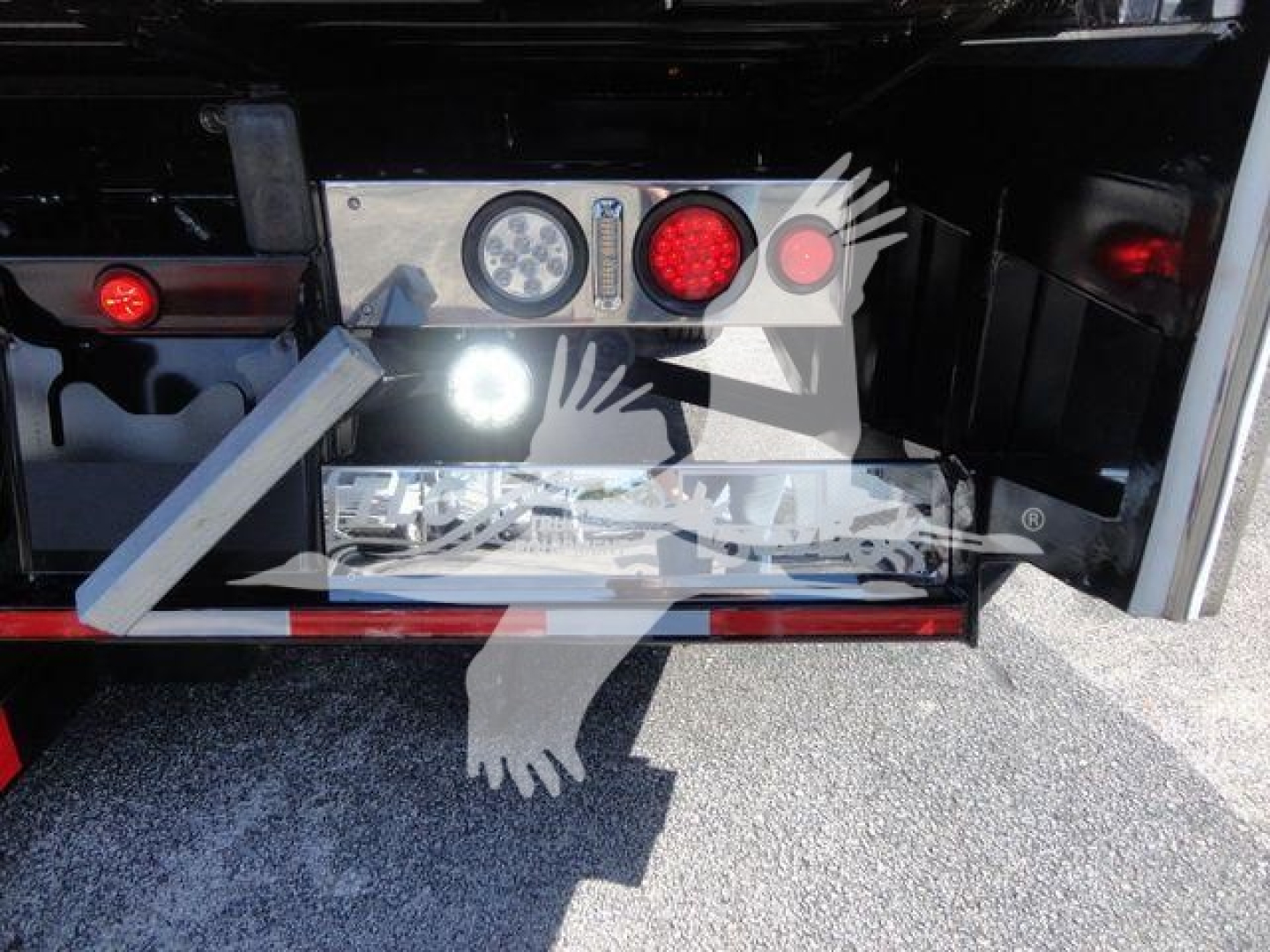 MD6 tow box rear showing control panel and LED lights on Mack MD6 rollback truck, with metal bumper and red reflectors.