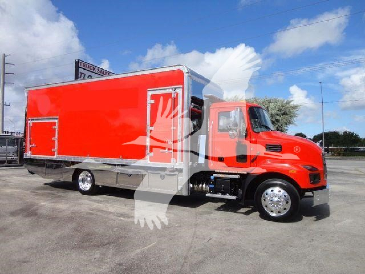 Truck body showing a red Mack MD6 rollback wrecker with a bright red cargo box and chrome wheels.