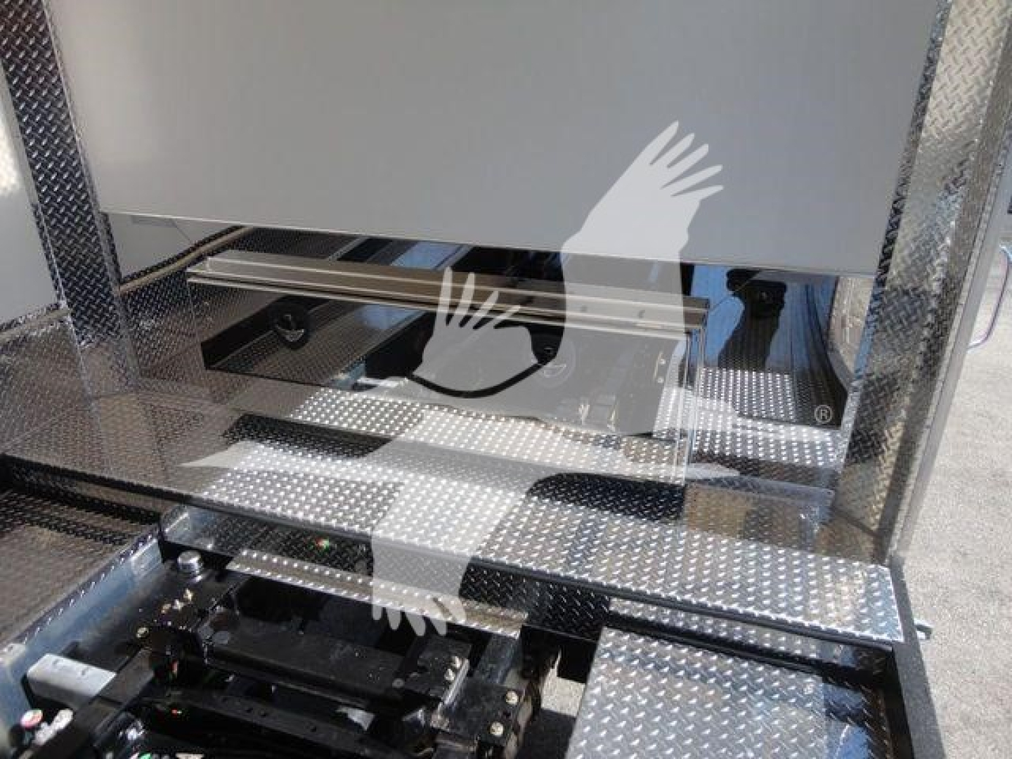 Mack MD6 rollback truck platform showing metal diamond plate steps and hydraulic components.