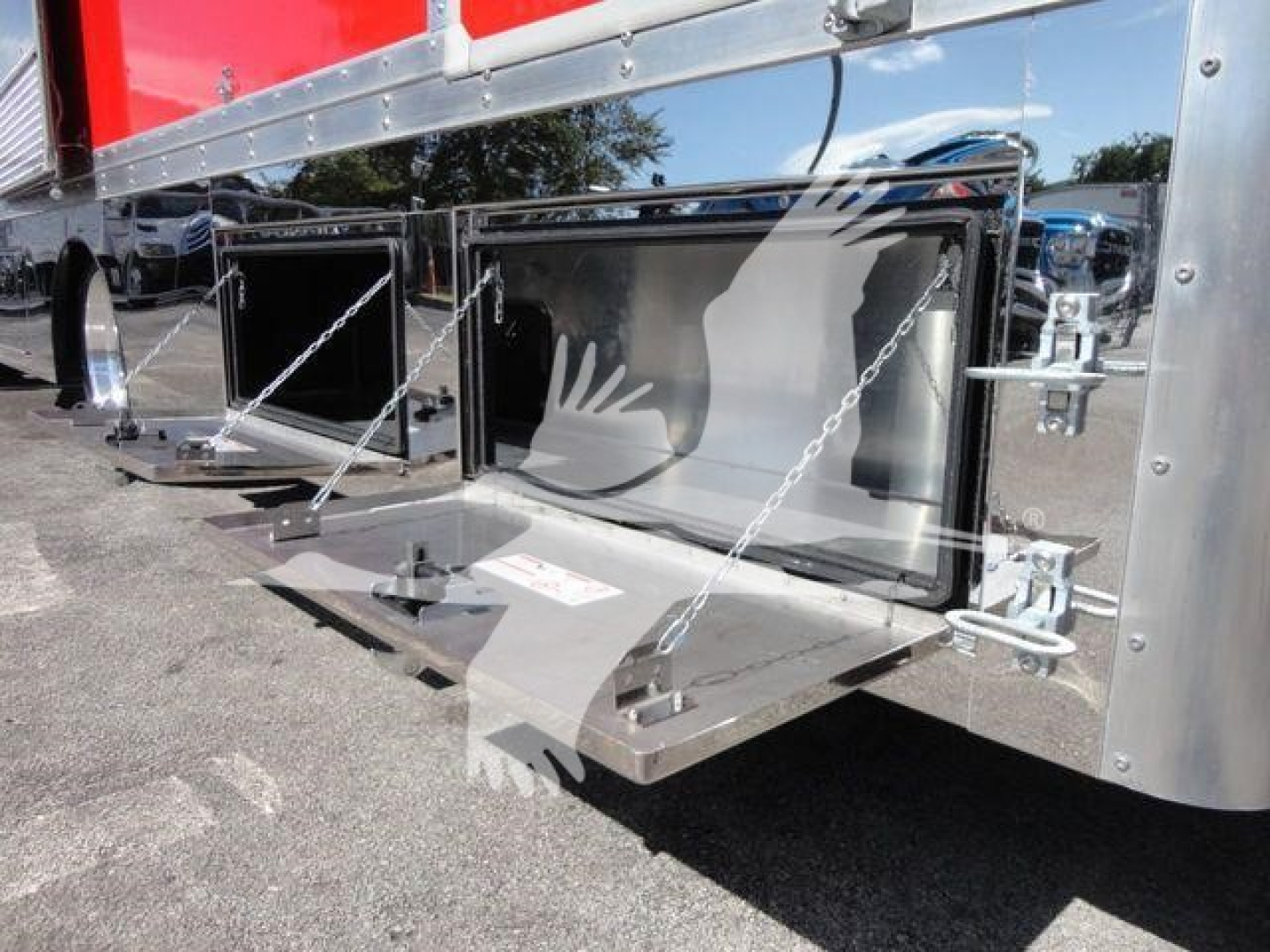 MD6 rollback truck with side storage compartments and hooks visible on side of trailer