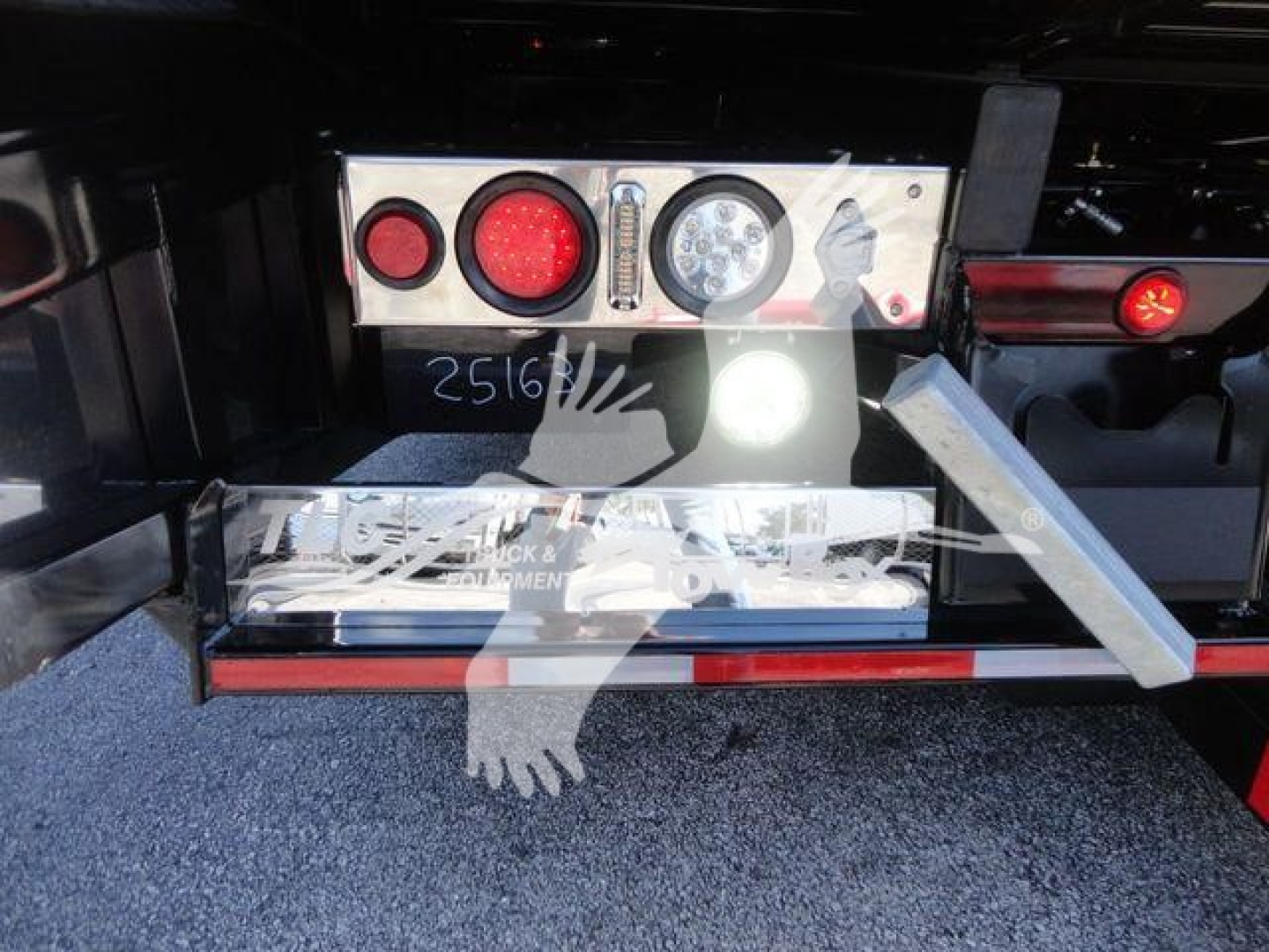 MD6 rollback truck rear showing dashboard with round taillights and control panel, metal step, and bumper.