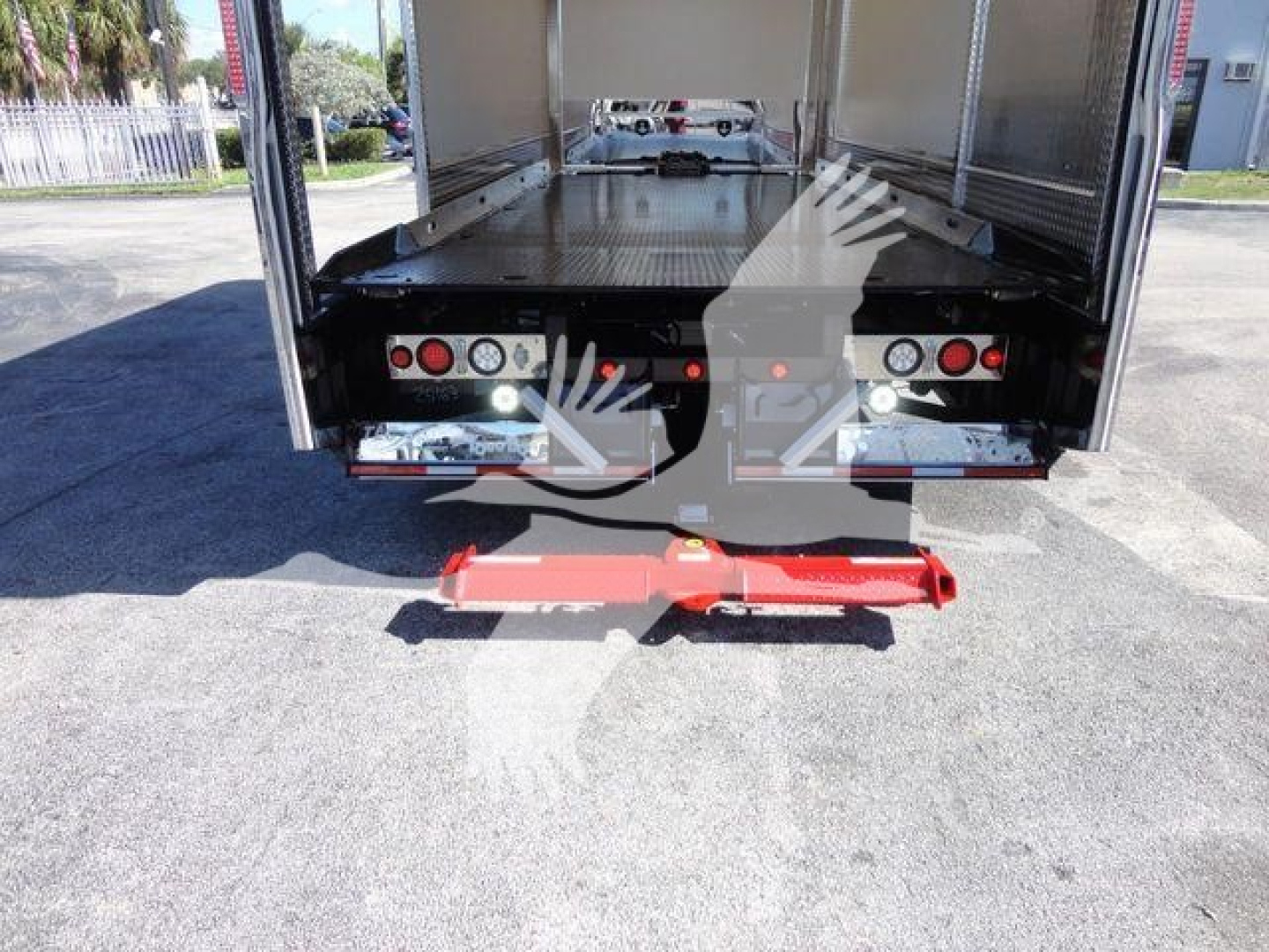 MD6 rollback truck tail with red rear stabilizer; rear platform with control panels and lights visible in cargo area.