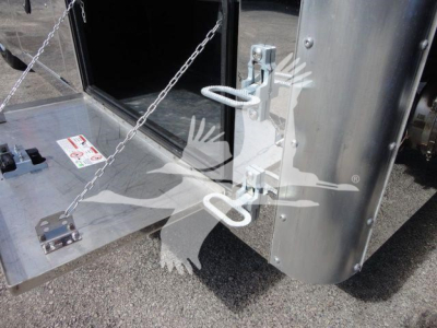 Truck component showing a metal toolbox/storage area with a chain and a latch; close-up of a towing hitch and vertical panel on a Mack MD6 rollback truck.
