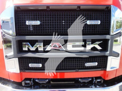MD6 Mack truck grille with large MACk letters and badge lights in foreground view.