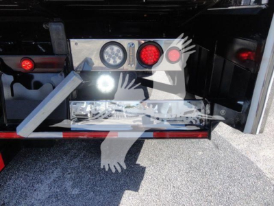 MD6 tow box rear showing control panel and LED lights on Mack MD6 rollback truck, with metal bumper and red reflectors.