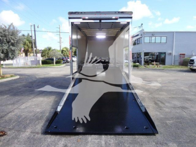MD6 Mack rollback truck cargo area with loading ramp open showing interior and bright lights.