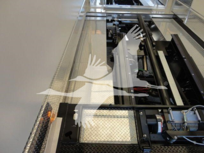 MD6 rollback truck setup showing internal chassis components and conveyor-like rails with diamond plate access panel.