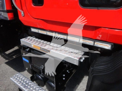MD6 Mack rollback truck image showing side steps and entry platform with Diamond tread pattern. Front bumper area visible with steps and black chassis.