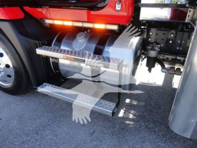 Truck side view showing chrome fuel tank, metallic steps, and undercarriage of a red Mack MD6 rollback truck.