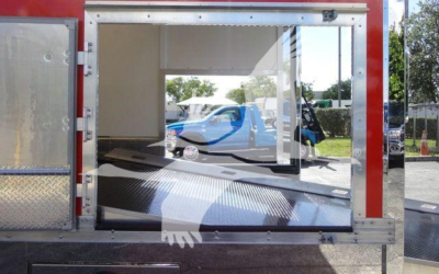 MD6 rollback truck body with open rear cargo space and reflective surfaces showing interior ramp and hydraulic equipment.