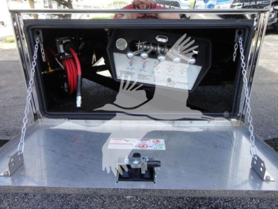 MD6 rollback truck compartment with control panel and hoses visible in the toolbox area.