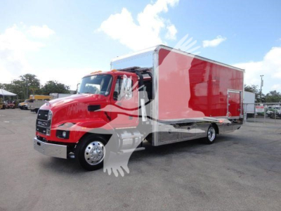 MD6 tow truck front angled view showing red cab and large red cargo box in a dealership yard.