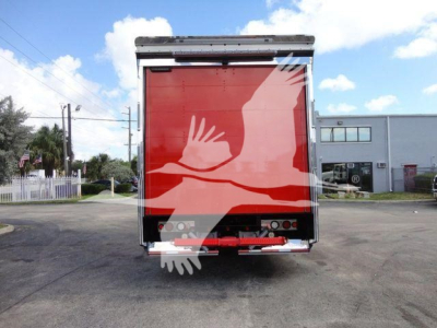 MD6 rollback truck rear showing red cargo door with white graphic hands image partial. Tail lights and bumper visible.