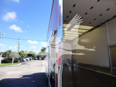 MD6 rollback truck interior loading area with open rear doors and exterior of trailer visible