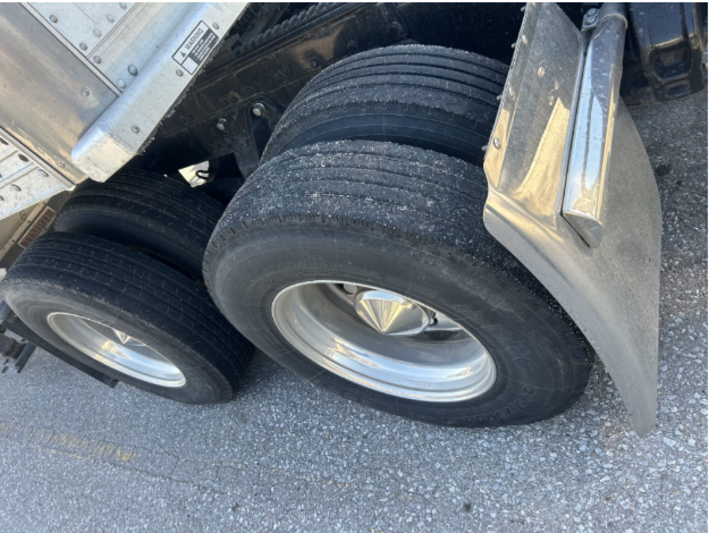 Dual rear tires on a Peterbilt 379 EXT truck showing wheel rims and fender underside.