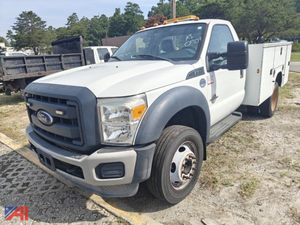 Ford F-550 Super Duty utility truck, white cab with black grille, large side mirrors, utility box on rear and front bumper-step, 2wd single rear wheel, daylight outdoor lot.