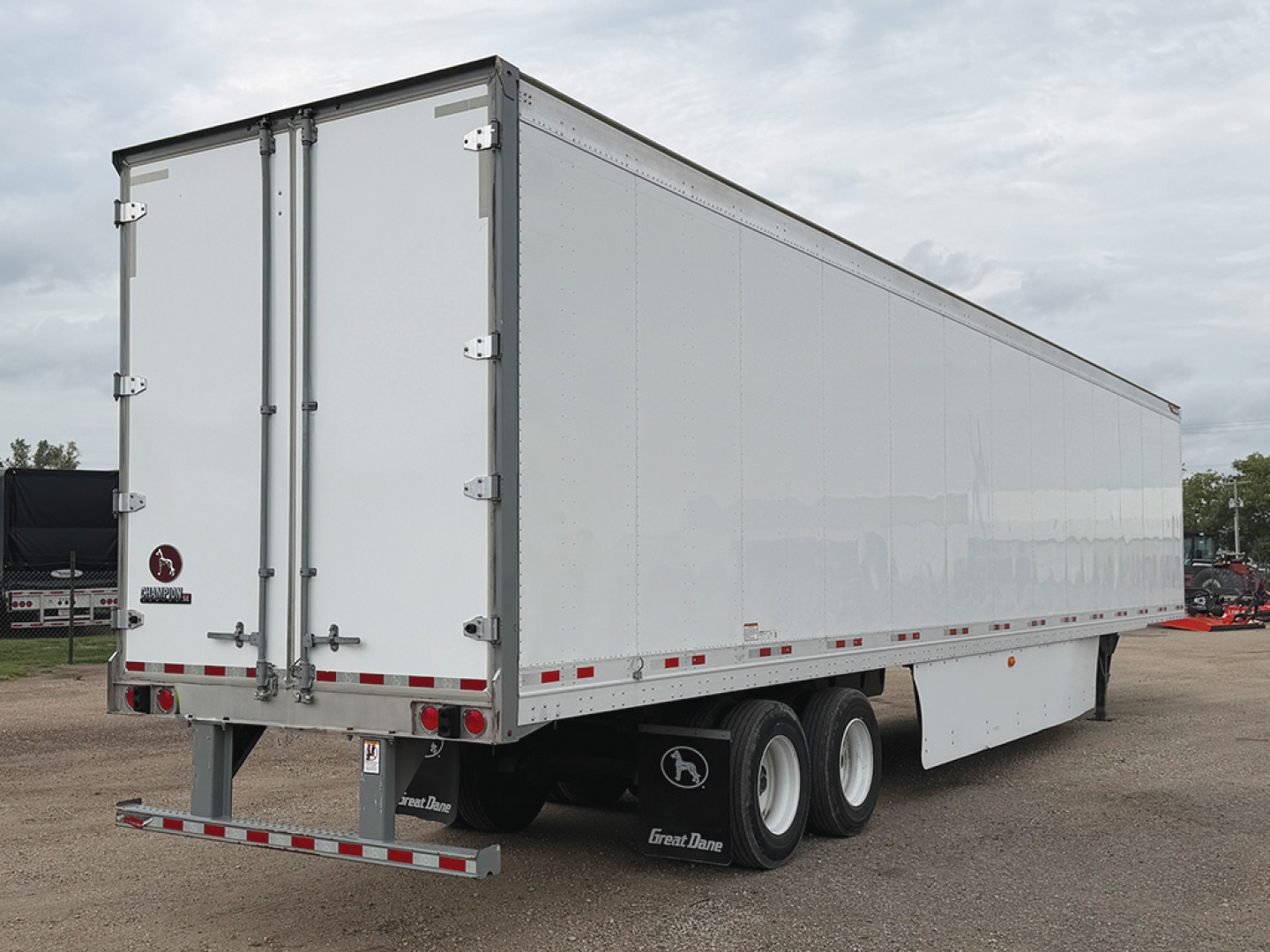 Great Dane Champion SE trailer showing rear and side panels with dual rear doors and triple-axle configuration.