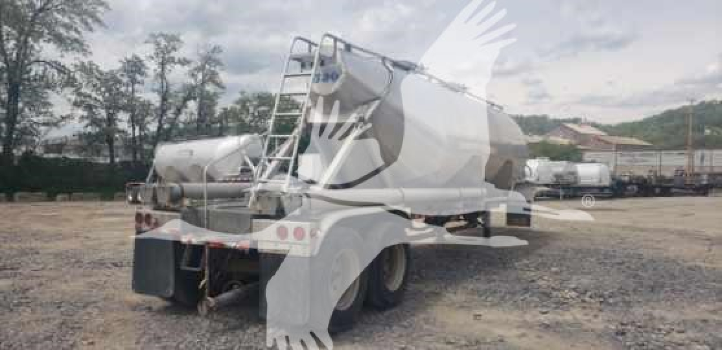 Trailer showing a 2012 Vantage Sand Tank pneumatic dry bulk trailer with rear view, dual axles, and white paint.