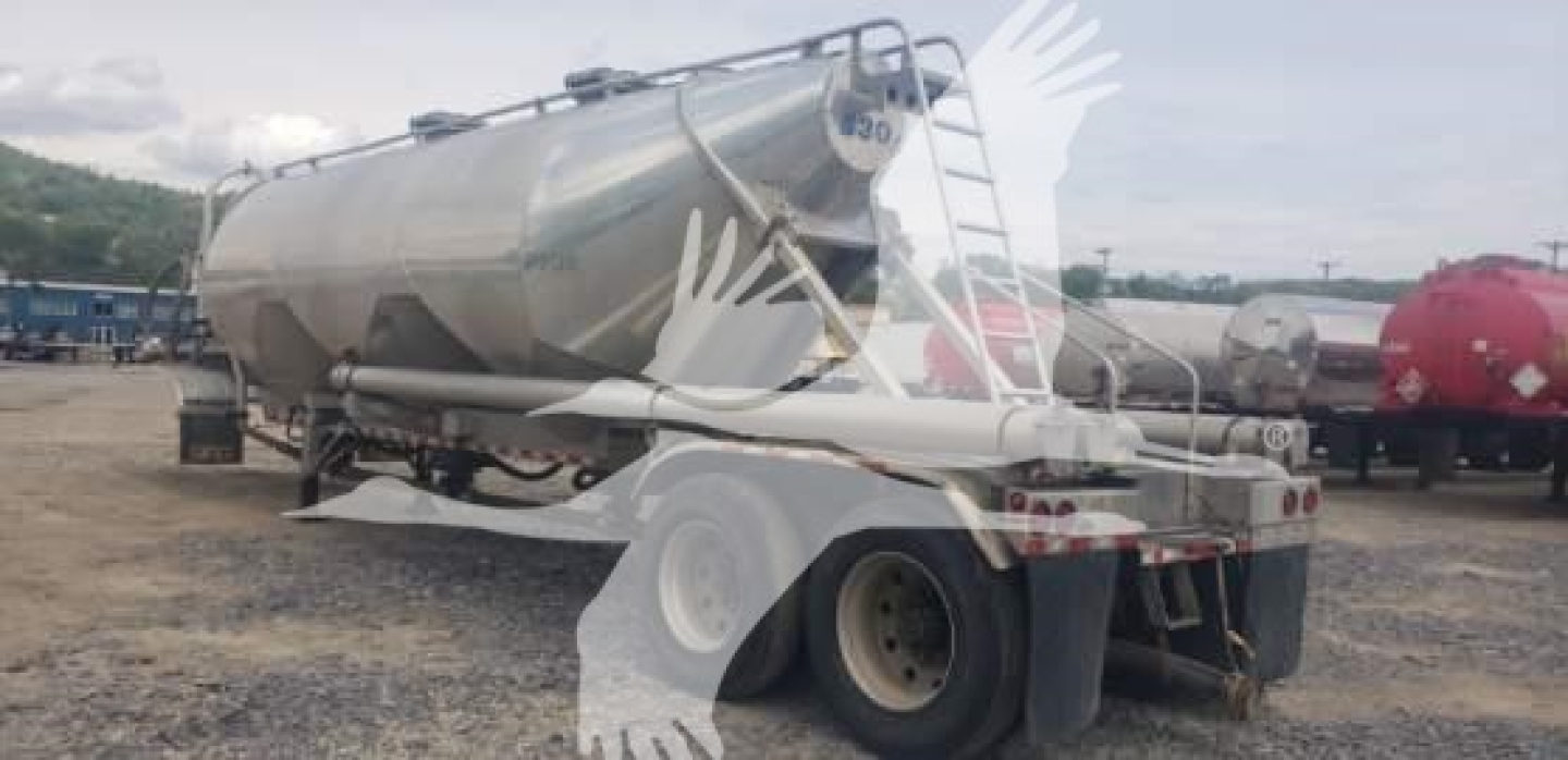 Vantage sand tank trailer viewed from rear-left with cylindrical steel tank and dual-axle setup.