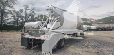 Trailer showing a 2012 Vantage Sand Tank pneumatic dry bulk trailer with rear view, dual axles, and white paint.