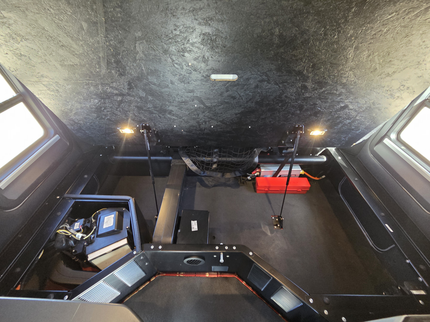 Kenworth T680 truck interior/cargo area showing under-bed storage and equipment mounts.