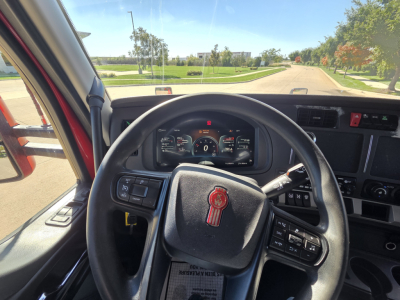 Kenworth T680 dash and steering wheel in cab view showing instrument cluster and steering controls.