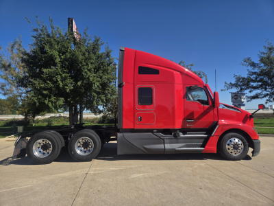 Kenworth T680 sleeper tractor side view showing red exterior and 3-axle rear with chrome wheels.