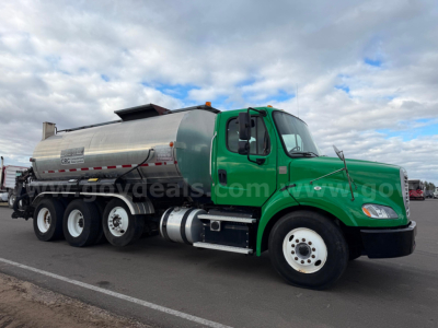 Freightliner Bearcat asphalt tanker truck with green cab and silver tank, side view