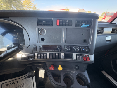 Kenworth T680 cab interior dashboard showing control panel, switches, and gauges.