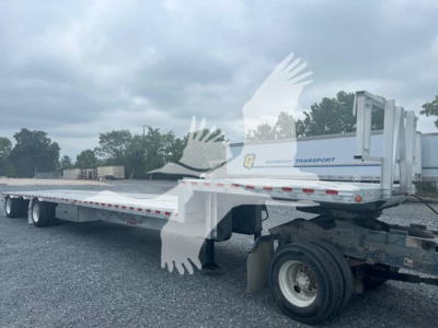 2019 Reitnouer Dropmiser trailer side view with drop deck and gooseneck hitch, white with Goodyear transport logo, flatbed sections, running gear visible.