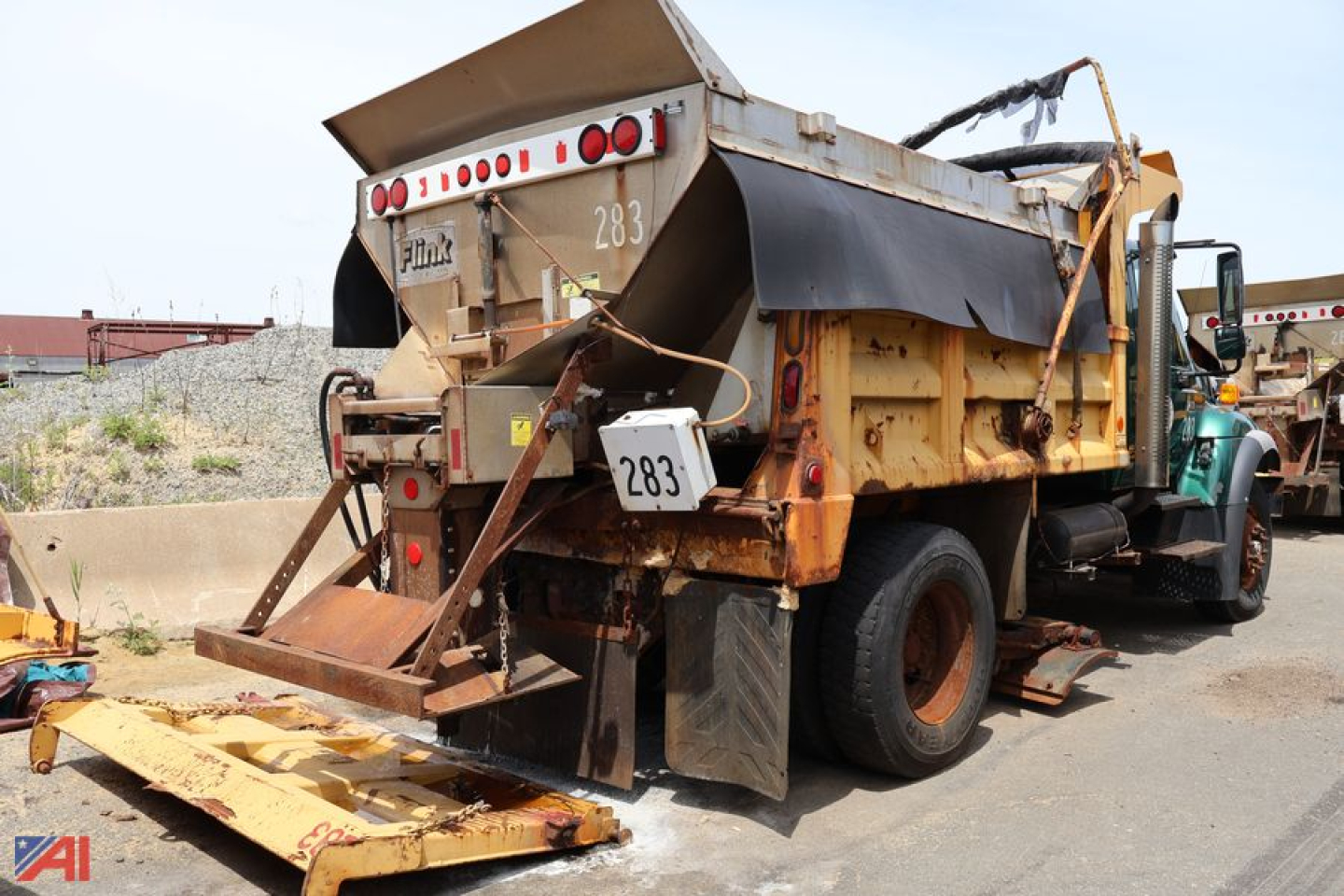 Dump truck showing rear hitch and hydraulic dump bed on International WorkStar 7400, tailgate, rust-free metal surfaces, number 283 tag.