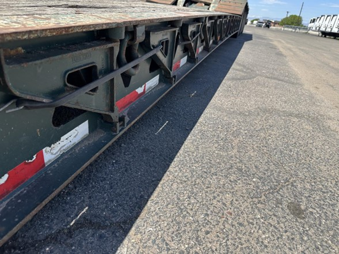 Trail King lowboy trailer side view showing undercarriage frame and reflective tape