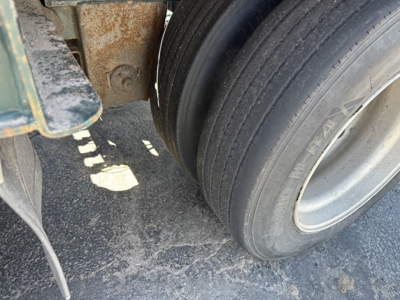 Trailer wheel area of a 2012 Trail King lowboy showing dual rear tires and chassis