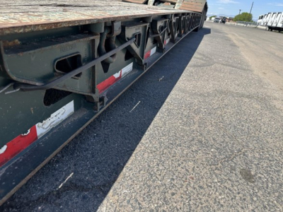 Trail King lowboy trailer side view showing undercarriage frame and reflective tape