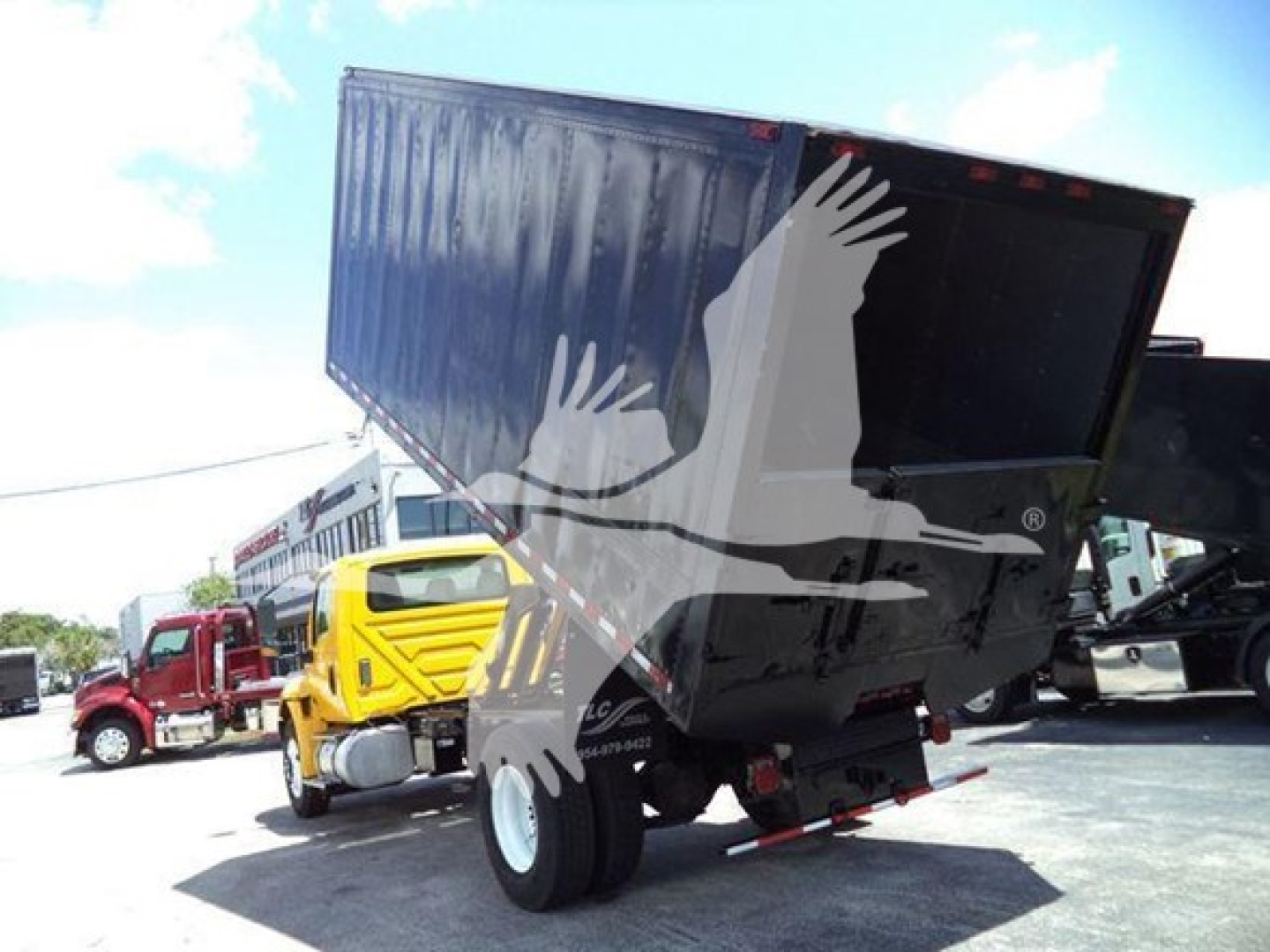 Dump truck with blue dump bed raised, International MV (2020) chipper category truck in used condition; visible VIN 3HAEUMMLXLL143630 and stock number T43630.