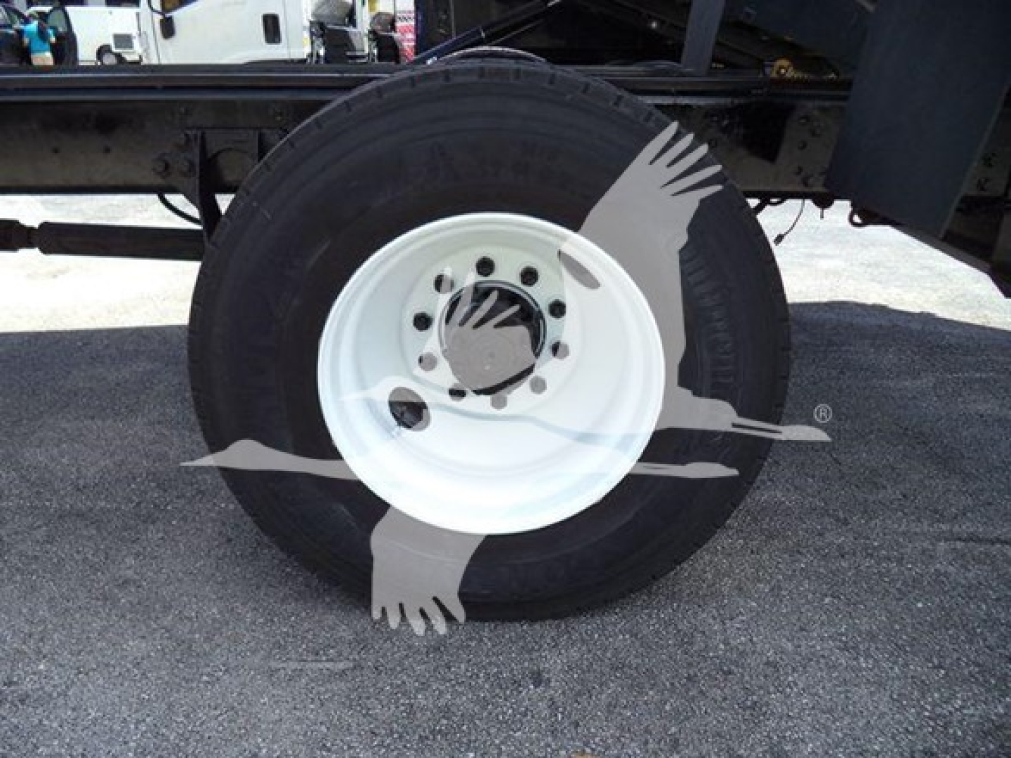 Wheel and tire assembly of a 2020 International MV truck chassis showing white steel rim and black tire.