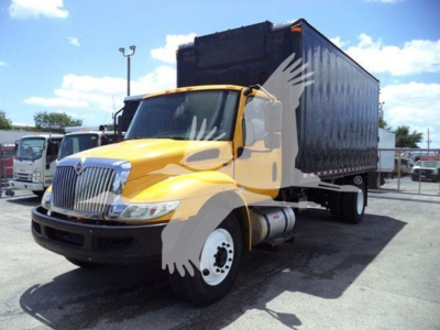 Truck cab with yellow hood and black dump bed, International MV 2020 model, side view showing front grille and wheel.