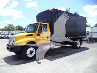 Truck cab with yellow body and black dumping bin, International MV model, side view, stock number T43630 visible.