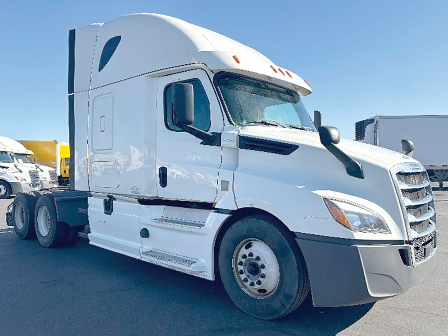 Truck engine bay area? No, image shows a white Freightliner Cascadia 126 sleeper cab tractor from a front-right angle. Text not visible.