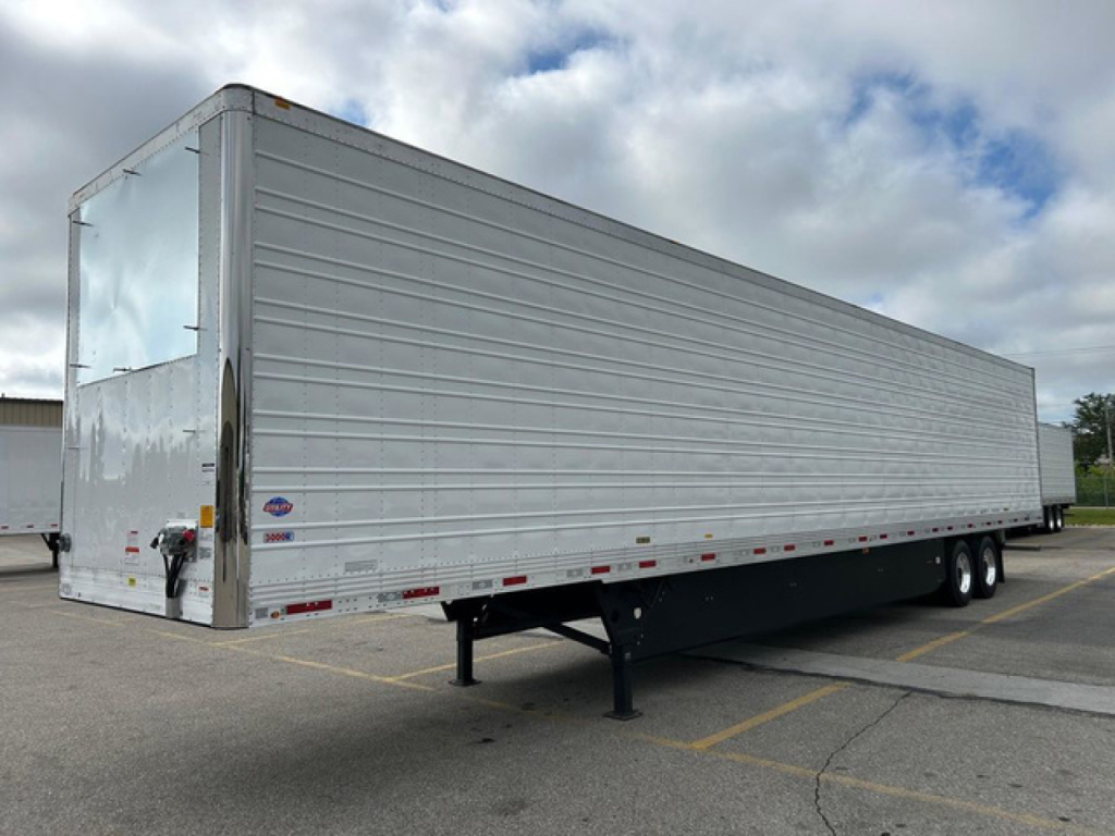 Utility reefer trailer showing aluminum sides and landing gear, roadside view, no hitch, side marker lights, closed doors, new condition.